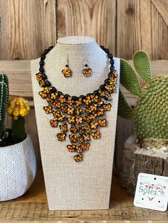 Beautiful Jewelry set made with a combination of Palm Tree Leaves hand woven into small beads and beautifully hand painted ceramic butterflies. This jewelry is Handmade With love by Mexican Artisans in Michoacán, Mexico. Pair with your favorite outfit and you will be the star of the show with this completely unique and handmade jewelry. Includes earrings and necklace. Handmade Butterfly Jewelry For Festivals, Handmade Butterfly Shaped Jewelry For Festivals, Mexico Jewelry Handmade, Adjustable Hand Painted Orange Jewelry, Hand Painted Adjustable Orange Jewelry, Traditional Black Woven Jewelry, Artisan Hand Painted Orange Jewelry, Traditional Black Handwoven Jewelry, Black Bohemian Woven Jewelry