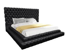 a bed that is made up with black leather and gold sheets on top of it