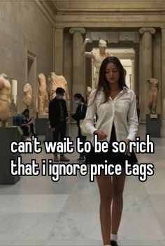 a woman standing in an art museum with the caption can't wait to be so rich that i ignore price tags