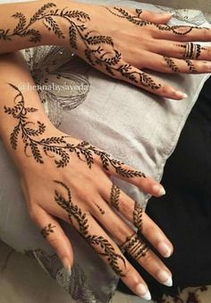 two women with henna tattoos on their hands