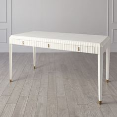 a white table sitting on top of a hard wood floor