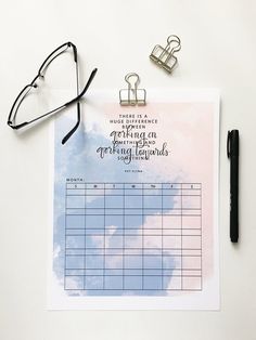 a clipboard with a calendar and glasses on it next to a pair of eyeglasses