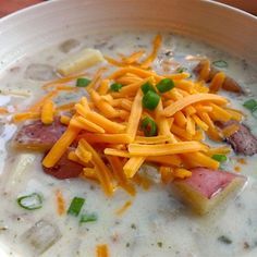 a bowl filled with soup and cheese on top of it