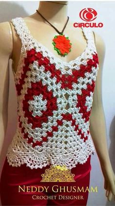 a crocheted top with red and white flowers on the chest, made to look like a flower