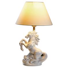 a table lamp with a white horse on it