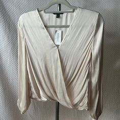 Banana Republic Msrp 79.50 Nwt. Pure Silk Blouse Creamy White Wrap Top With Metal Modesty Clip And Breast Line . Pit To Pit 21” Length 21”& Sleeve Is 16” From Pit To Wrist That Have Shell Button Closure. New Condition With Tags. Elegant Cream Blouse For Night Out, Cream Long Sleeve Top For Night Out, Beige V-neck Tops For Formal Occasions, Beige V-neck Blouse For Night Out, Cream V-neck Blouse For Party, Formal Beige V-neck Tops, Cream V-neck Party Blouse, Sleeveless Blouse Pattern, Affordable Cream V-neck Blouse