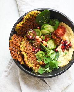 a black bowl filled with different types of food