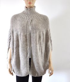 Cozy Alpaca Cape For Winter, Cozy Chunky Knit Wool Knitting Pattern, Oversized Knit Acrylic Outerwear, Oversized Knitted Winter Cape, Cozy Poncho For Cold Weather, Cozy Chunky Knit Merino Wool Pattern, Cozy Chunky Knit Merino Wool Knitting Pattern, Cozy Chunky Knit Pattern In Merino Wool, Chunky Knit Wool Knitting Pattern For Cold Weather