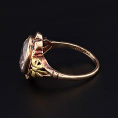 A gorgeous synthetic spinel from the late Art Deco era (circa 1930-1940). This vintage ring features a clear synthetic spinel set in 10k gold with bows around the stone. The face of the ring measures 0.6 inches by 0.5 inches wide and the piece is in excellent condition. It is currently a size 5 but can be resized free of charge. Materials: 10k gold, synthetic spinel. Vintage 14k Stamped Sapphire Ring For Formal Occasions, Antique Collectible Diamond Ring With Gemstone, Antique 14k Gold Birthstone Ring For Formal Occasions, Collectible Vintage Emerald Cut Diamond Ring, Vintage Signet Ring With Center Stone For Promise, Antique Collectible Birthstone Ring, Antique 14k Gold Birthstone Ring, Antique Gold Sapphire Ring Collectible, Vintage Gold Topaz Ring With Rose Cut Diamonds