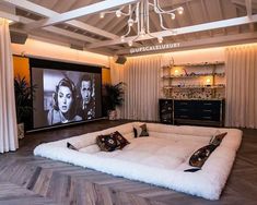 a living room filled with furniture and a flat screen tv mounted to the wall above it