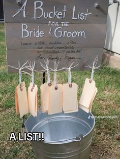 a bucket list for the bride and groom is hanging on a sign that says, a bucket list for the bride and groom