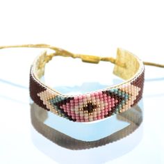 Rhomboid native design bracelet on leather (pk/bw) Rhomboid native design bracelet on leather (pink/brown). Made in California. K&Z Jewelry Bracelets Pink Resizable Beaded Bracelets For Festival, Pink Resizable Friendship Bracelets For Festival, Southwestern Style Brown Festival Bracelets, Brown Braided Friendship Bracelets, Handmade Southwestern Brown Leather Bracelet, Southwestern Brown Bracelets, Etkie Bracelet, Southwestern Hand-tooled Brown Bracelets, Native Design