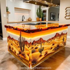 a kitchen island painted with desert scenes and cacti on the countertop is shown