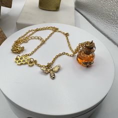 Bee Decor Bottle Charm Necklace New. Chain Measures 18” And Has A 3” Extender. On The Chain There Is A Piece Of A Honey Comb As Well As A Honey Bee Charm. The Honey Comb Measures 1/2” X 1/2”. The Honey Bee Charm Measures 1/2” X 5/8”. The Honey Comb Is Fixed To The Chain But The Bee Charm Moves. Then There Is A Jar With A Cork Lid With What Is Supposed To Look Like Honey Inside It. It Measures 7/8” X 1/2”. It Also Has A Honey Bee On The Outside Of It. This Necklace Is Absolutely The Cutest Thing Handmade Honey Color Jewelry Gift, Handmade Honey Jewelry For Gift, Handmade Honey-colored Jewelry For Gifts, Honey Jewelry, Bottle Charms, Cork Lid, Bee Decor, Bee Charms, Jewelry Lookbook