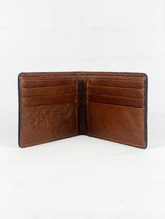 The Men's Bi-Fold Western Wallet with Tooled Accent is a sophisticated blend of functionality and Western charm. Crafted from high-quality leather, this wallet is both durable and stylish, perfect for the modern cowboy with a taste for traditional Western style. The exterior of the wallet features a meticulously tooled Western flower accent, adding an element of artistic craftsmanship that sets this wallet apart. Its bi-fold design opens to a well-organized interior, complete with multiple card slots for credit cards and business cards, alongside a divided cash pocket that allows for easy segregation of bills and receipts. Whether it's for your own daily use or as a special gift, this wallet is designed to impress with its elegance and practicality. Closure Type Bi-fold Size 4.5"w x 3.5"h Rugged Bifold Wallet For Everyday Use, Classic Bifold Wallet With Leather Patch, Distressed Brown Bifold Wallet For Everyday Use, Rugged Brown Bifold Wallet, Brown Bifold Wallet For Business, Brown Leather Wallet With Leather Patch, Brown Leather Wallet For Everyday Carry, Brown Leather Lined Wallet For Everyday Carry, Brown Wallet With Leather Lining For Everyday Carry