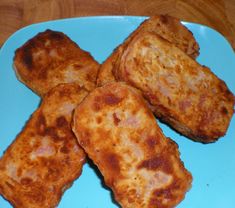 four pieces of fried food on a blue plate