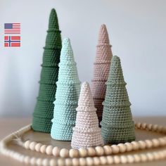 crocheted christmas trees are displayed on a table