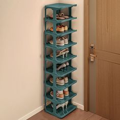 there is a shoe rack with many pairs of shoes on it next to the door