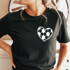 Show off your Soccer Heart with this ultra comfy unisex Tee! Fashioned with retail quality and a soft touch, it's the perfect thing to wear while you show the world your dedication to the game. Get yours and make a statement - catch the eye of other Soccer Lovers without even kicking a ball! *This listing has a 2 week turn around due to the nature of the customization* Sizing Policy:We try our best to describe the fit and style for each item in the listing but each body is uniquely shaped. You c Black T-shirt With Heat Transfer Vinyl For Sports Season, Black Sports Tops With Heat Transfer Vinyl, Black Sports Fan Top With Screen Print, Black Casual T-shirt For Football Season, Casual Black T-shirt For Football Season, Black T-shirt For Sports Season With Heat Transfer Vinyl, Black T-shirt With Heat Transfer Vinyl For Sports, Casual Black T-shirt With Heart Shape, Casual Black Heart-shaped T-shirt