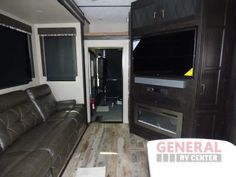 the inside of an rv with couches and television