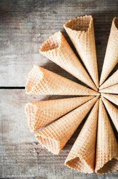 an ice cream cone is arranged in the shape of a star on a wooden surface