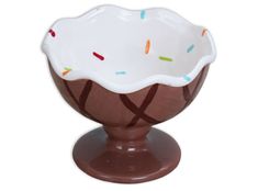 a brown and white bowl with sprinkles on it sitting on a stand