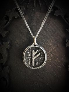 a silver pendant with the letter y on it's side, hanging from a chain