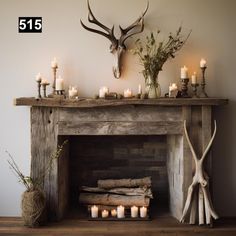 a fireplace with candles and deer heads on it