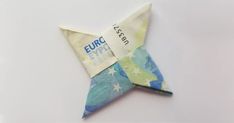 an origami star with the word euro on it is shown in blue, green and white