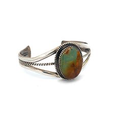 Vintage Navajo Turquoise Sterling Silver Cuff Bracelet - This classic cuff showcases a stunning turquoise stone with lovely green and brown hues. Its metalwork boasts a serrated bezel and double-layered bead embellishments, while the triple wire cuff offers both comfort and durability. A truly earthy piece to add to your collection! Turquoise Green & Brown Matrix Size: Medium 6 1/2" Cuff includes 1" Gap Inner circumference 6 1/2" total Stone Setting: 1.25"L x 1"W Metal: Sterling Silver Artisan Signed: RB Stamped: Sterling Weight: 31.3 Grams This listing is for (1) Cuff only Explore our curated selection of exceptional Vintage Bracelets here. Discover the entire 'Silver Raven' Vintage Collection for yourself. Southwestern Bangle Cuff Bracelet With Natural Stones, Southwestern Style Natural Stones Cuff Bangle, Bohemian Oval Gemstone Cuff Bracelet, Adjustable Southwestern Green Cuff Bracelet, Adjustable Green Southwestern Cuff Bracelet, Southwestern Green Bangle Jewelry, Southwestern Style Green Bangle Jewelry, Raven Jewelry, Wire Cuff