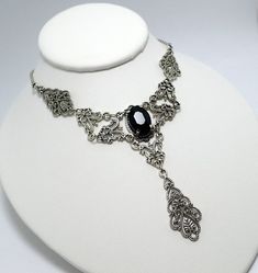 This is a new handmade necklace. It is made with antiqued silver plated filigrees, accented with a high quality JET BLACK glass rhinestone. Decorated portion is 6" wide and 3 1/4" tall in the center. Necklace is adjustable 15-18" with a lobster clasp and chain extender. If you would like a different length, please send us a message. Adjustable Gothic Necklace For Formal Occasion, Gothic Sterling Silver Choker Necklace, Gothic Filigree Metal Jewelry, Gothic Antique Silver Jewelry With Intricate Design, Gothic Silver Pewter Jewelry, Gothic Metal Jewelry With Filigree, Gothic Antique Silver Jewelry For Gift, Gothic Antique Silver Jewelry For Formal Occasions, Victorian Antique Silver Necklace