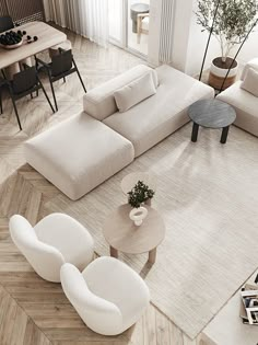 an aerial view of a living room with white furniture