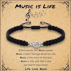 a black cord bracelet with music is life written on it and an image of a treble