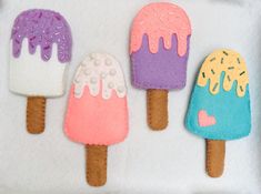 three ice cream popsicles with sprinkles on them