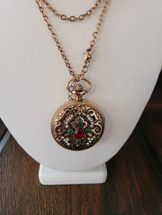 Victorian style pocket watch with two carat teardrop ruby stone and one carat emerald stones.  Zircon accents.  14K gold plated.  Created emerald/ruby/zircon. Timeless Antique Gold Jewelry Gift, Elegant Round Pocket Watch For Evening, Elegant Pocket Watch As Gift, Elegant Gold Pocket Watch As Gift, Elegant Evening Pocket Watch, Elegant Gold Pocket Watch For Evening, Elegant Gold Pocket Watch Gift, Elegant Pocket Watch With Metal Dial For Anniversary, Elegant Gold Round Pendant Pocket Watch