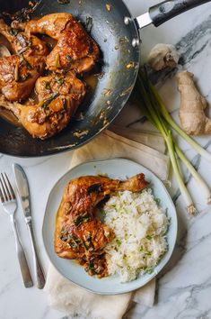 chicken and rice in a skillet on a marble table