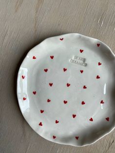 a white plate with red hearts on it