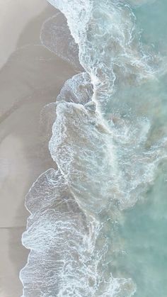 an aerial view of the ocean and beach