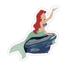 the little mermaid sitting on top of a rock with her arms out in the air