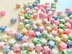 many different colored stars on a white surface