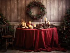 a table topped with candles next to a christmas wreath