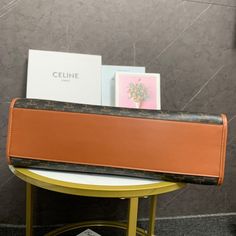 a brown and black purse sitting on top of a table