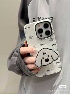 a person holding a phone case with a dog on it