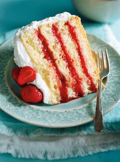 a slice of cake on a plate with strawberries