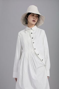 Asymmetric Folding Curved Pleated Middle Long Shirt Tunic – Ofelya Boutique Spring Tops With Buttons And Asymmetrical Hem, Spring Tops With Asymmetrical Hem And Buttons, Spring Pleated Button-up Tops, Casual Collared Pleated Tops, White Pleated Long Sleeve Top, White Long Sleeve Pleated Top, Casual Pleated Collared Blouse, Spring Collared Pleated Top, Spring Pleated Collared Tops