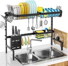 a kitchen sink filled with lots of dishes and utensils next to a counter