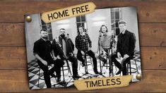 a group of people sitting on stools in front of a wooden wall with the words home free