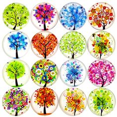 a bunch of glass plates with trees painted on them, all in different colors and shapes