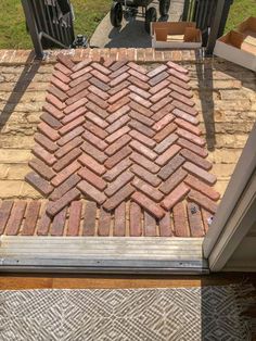 a brick walkway is being installed on top of a house