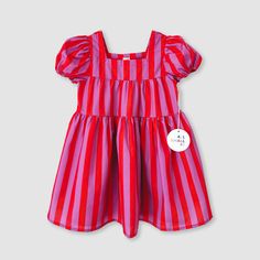 Small will be the star of the show - or should we say circus?! Look absolutely adorable at your next event wearing our Pink Stripe Tier Dress with its pink stripes, 3-tier design, puff sleeves, and midi length. Perfect for any season, so no need to clown around when it comes to being a style icon.  65% Cotton 35% Polye